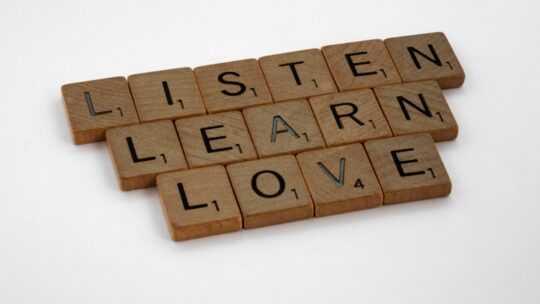 Leader actively listening to team member in professional setting