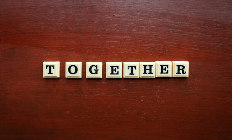 Two corporate teams coming together during merger